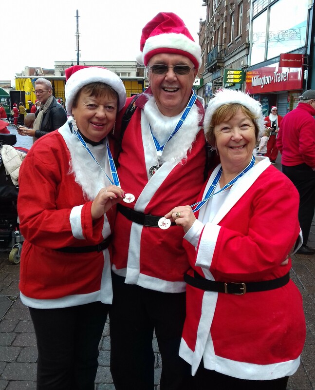 Finishers at the Rotary Santa Fun Run showing off their medals